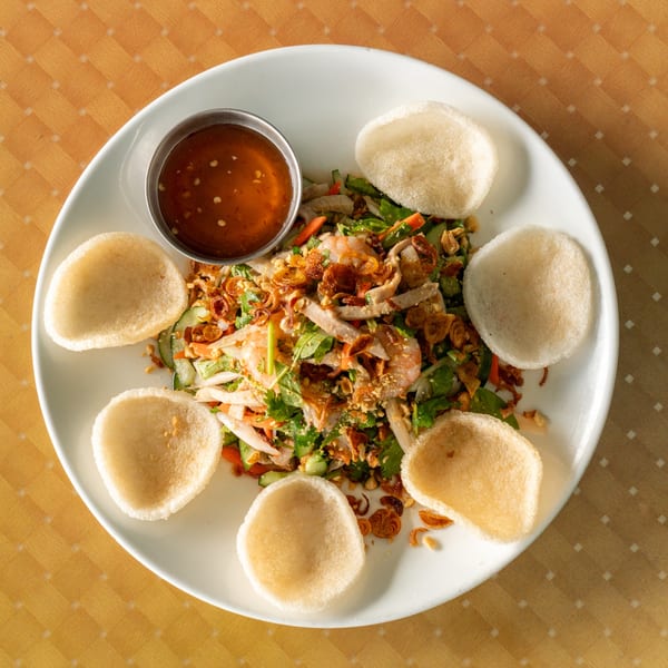 Vietnamese chicken and shrimp salad with herbs, peanuts, fried shallots, and shrimp crackers.